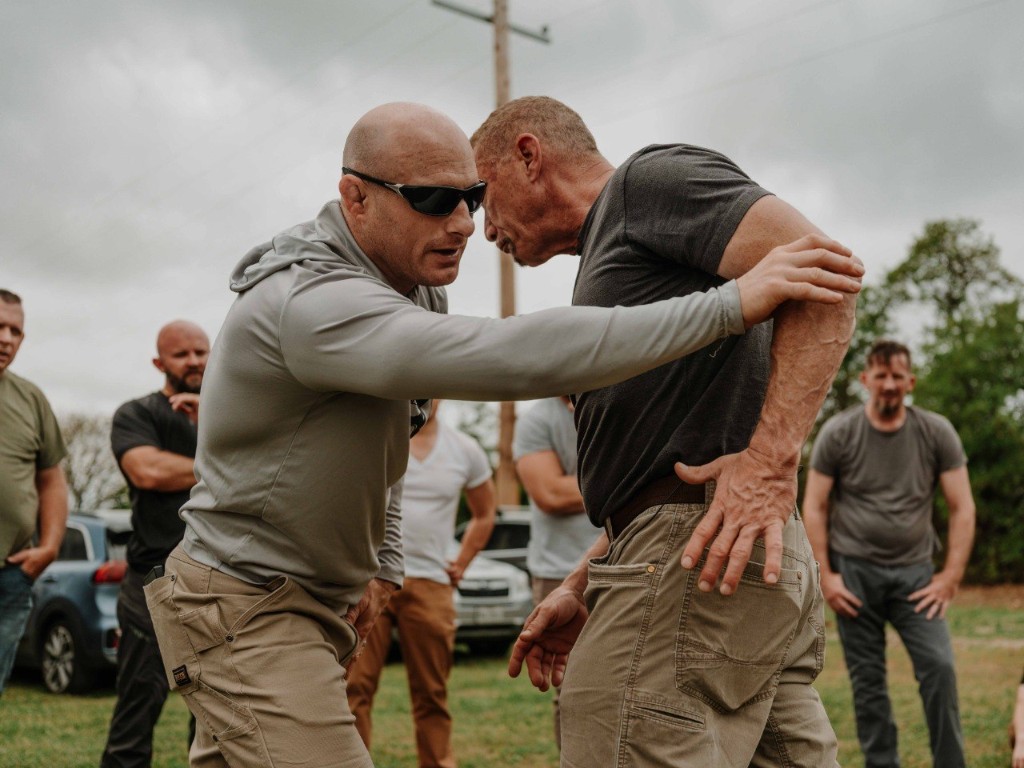 Instructors demonstrating contact management during outdoor ShivWorks training